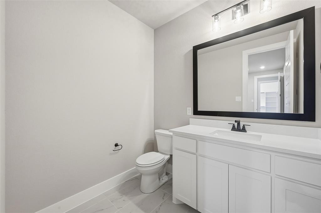 1053 Llano Way Poolville, TX 76487 - Photo 21 of 40 a bathroom with a toilet sink and mirror