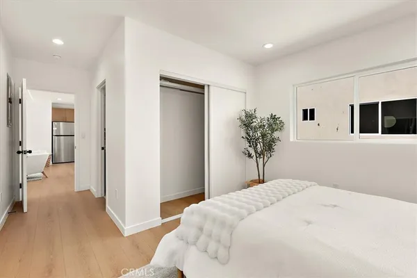 a bedroom with a large bed and a chandelier