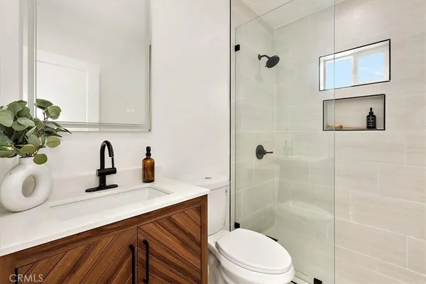 a bathroom with a sink a toilet and shower
