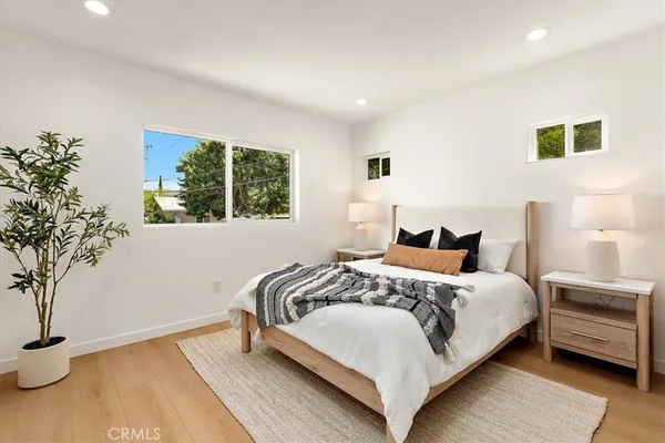 a bedroom with bed and a potted plant