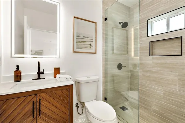 a bathroom with a sink a toilet and shower