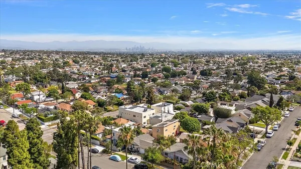 an aerial view of residential houses with city view