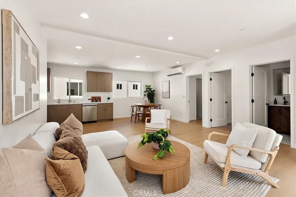 a living room with furniture and kitchen view