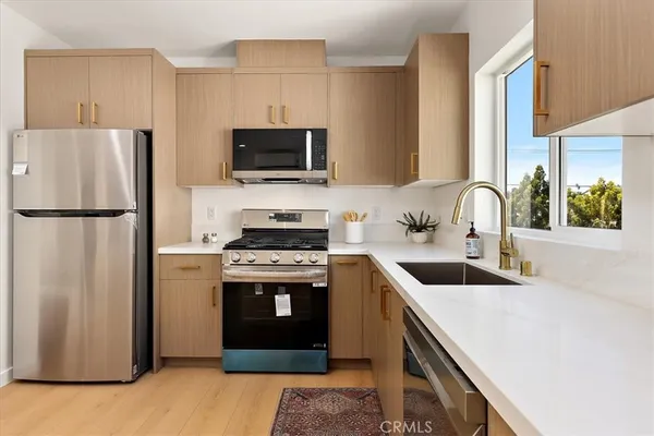 a kitchen with a refrigerator stove and sink