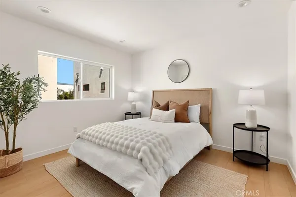 a bedroom with bed and a potted plant