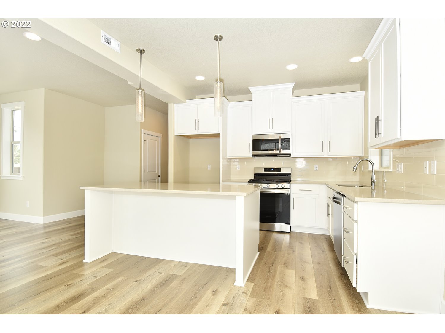 4791 Southwest 179th Avenue Beaverton, OR 97078 - Photo 11 of 27 a kitchen with granite countertop a stove a sink and a refrigerator