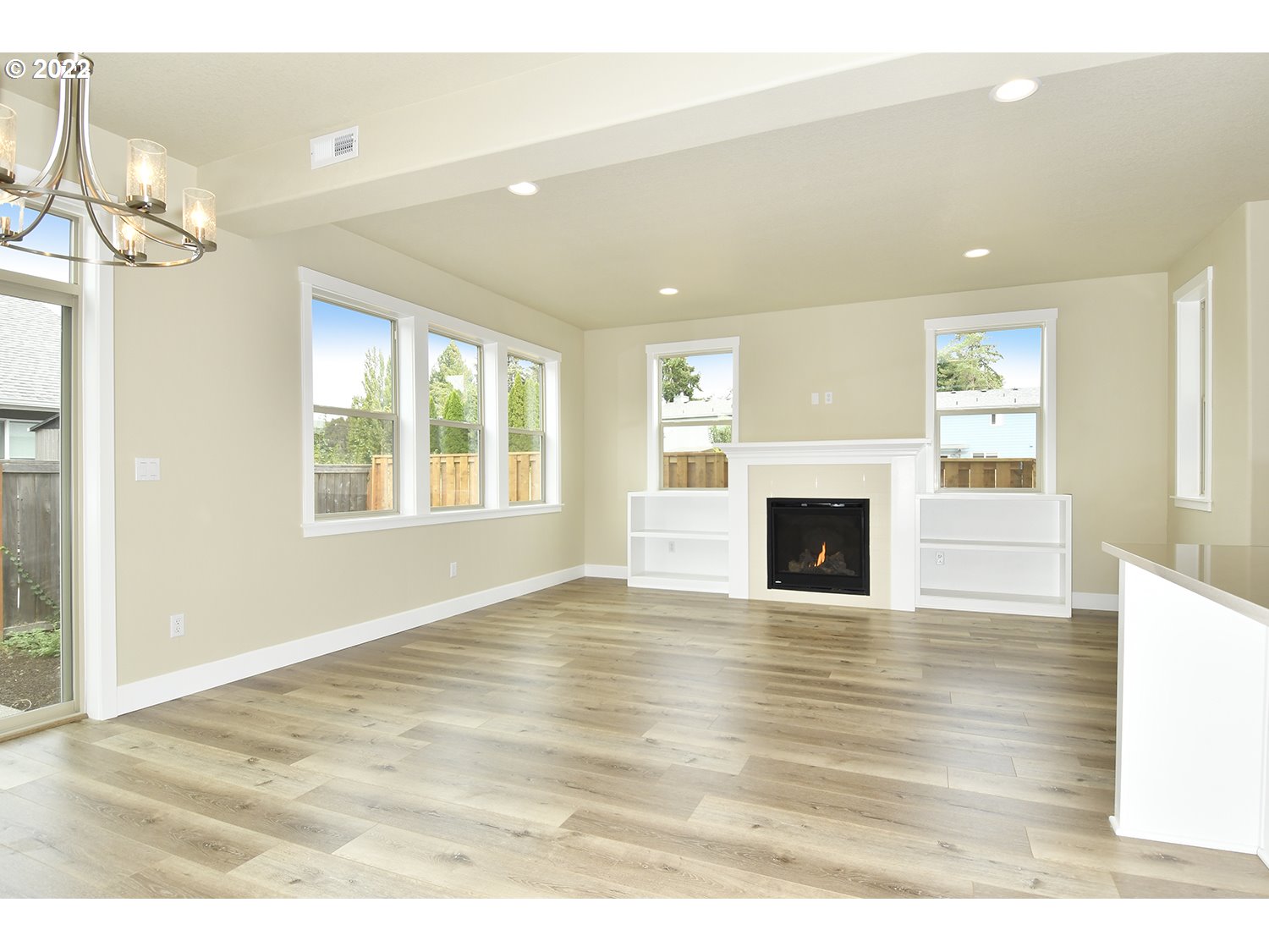 4791 Southwest 179th Avenue Beaverton, OR 97078 - Photo 6 of 27 a view of empty room with wooden floor and fireplace