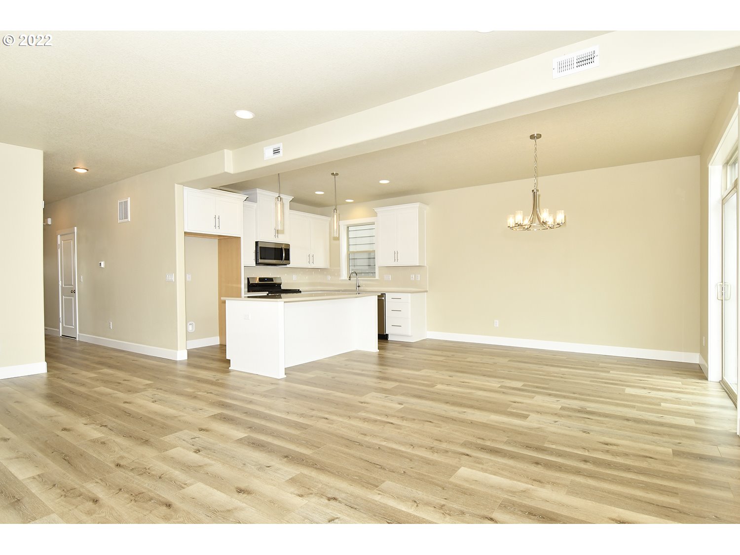 4791 Southwest 179th Avenue Beaverton, OR 97078 - Photo 7 of 27 a view of kitchen and empty room with wooden floor