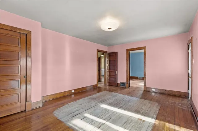 a view of an empty room and wooden floor