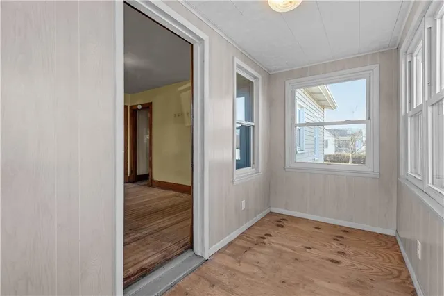 an empty room with windows and closet