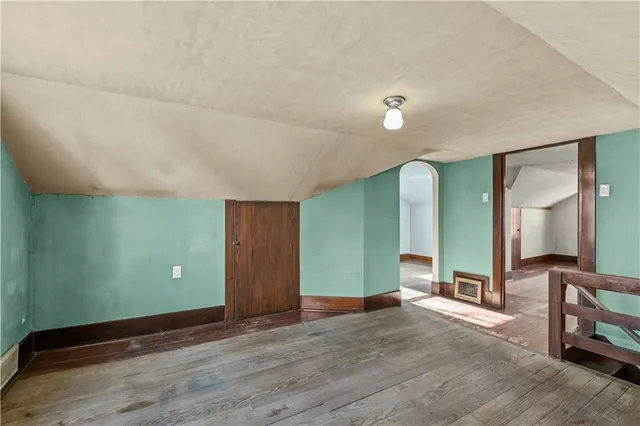 a view of a room with wooden floor