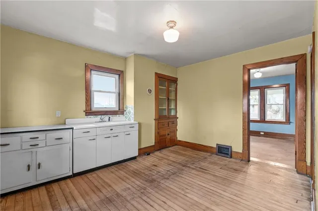 a spacious bathroom with a granite countertop sink and a mirror
