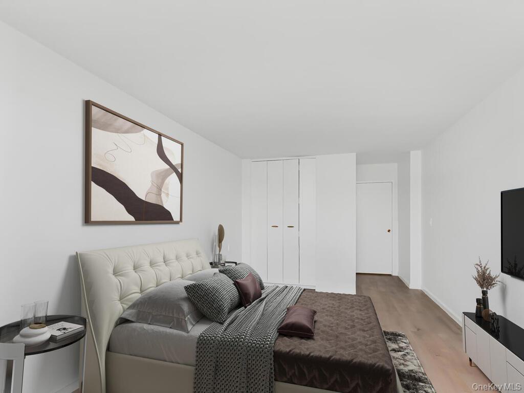 555 Kappock Street, Unit 16K Bronx, NY 10463 - Photo 12 of 16 Bedroom with light wood-type flooring and a closet