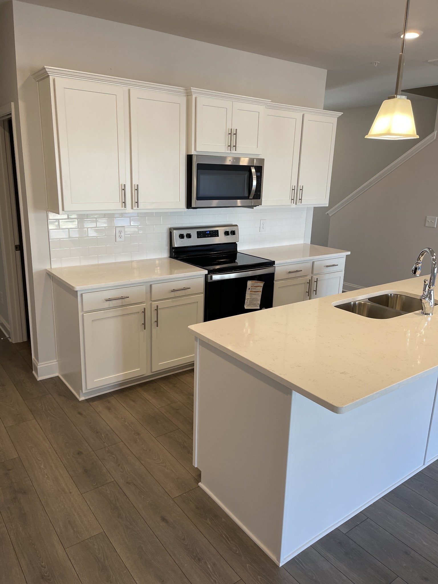 1203 June Wilde Ridge Spring Hill, TN 37174 - Photo 2 of 20 a kitchen with stainless steel appliances a stove a sink and a microwave