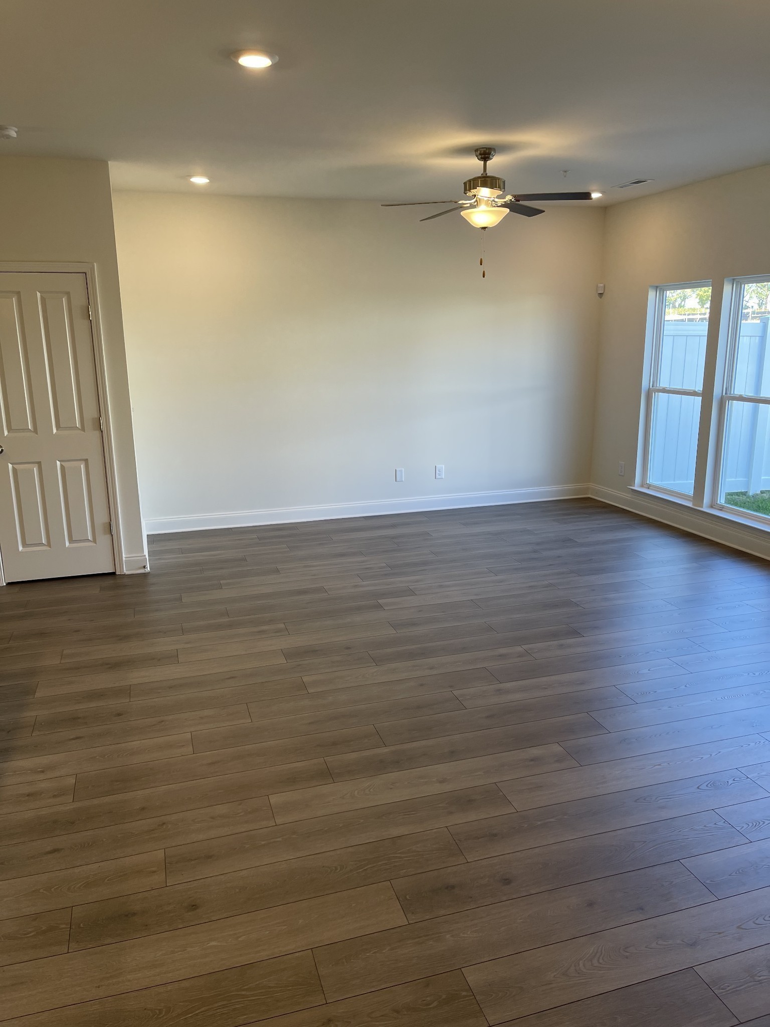 1203 June Wilde Ridge Spring Hill, TN 37174 - Photo 6 of 20 a view of an empty room with wooden floor and a window