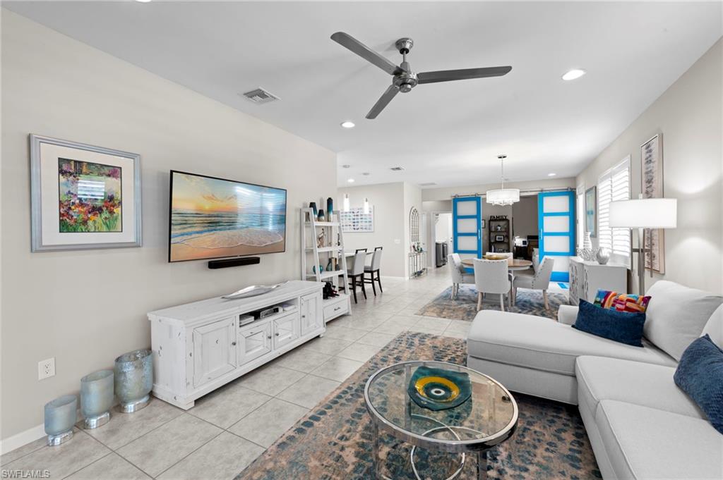 20179 Torch Key Way Estero, FL 33928 - Photo 11 of 41 a living room with furniture and a flat screen tv