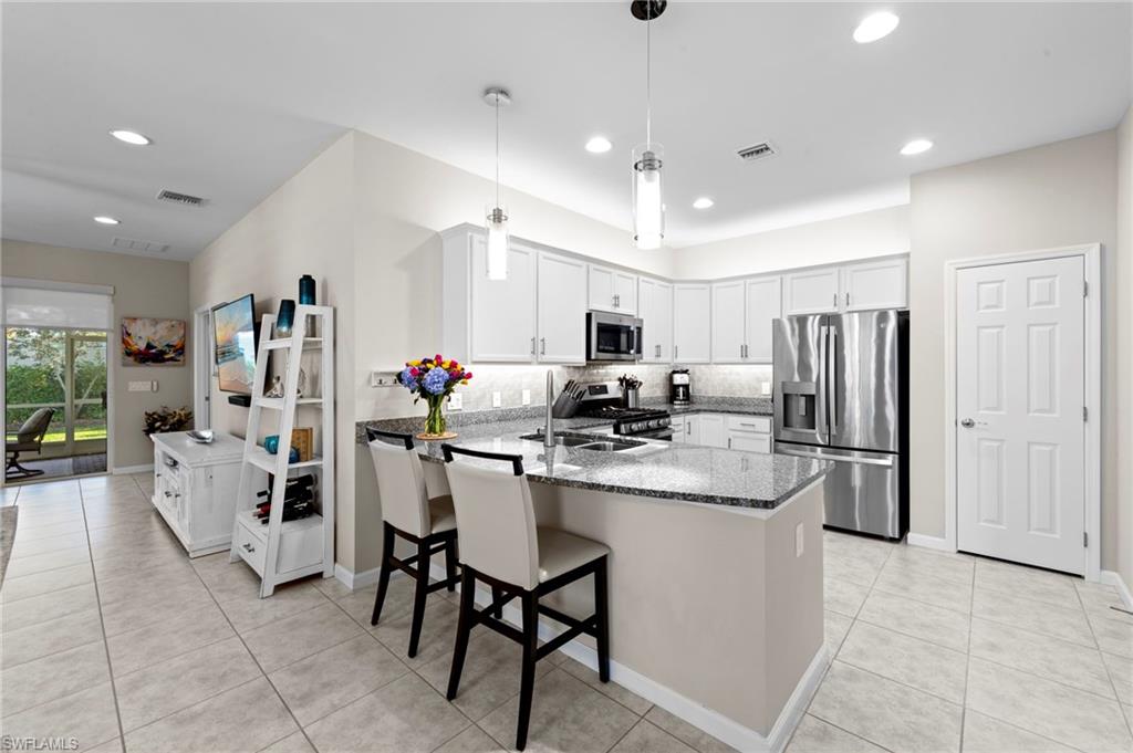 20179 Torch Key Way Estero, FL 33928 - Photo 15 of 41 a kitchen with counter space cabinets and appliances