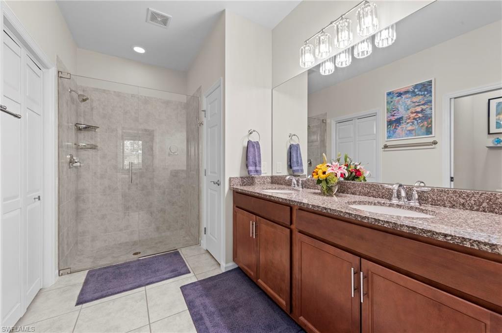 20179 Torch Key Way Estero, FL 33928 - Photo 20 of 41 a bathroom with double vanity sinks and a shower