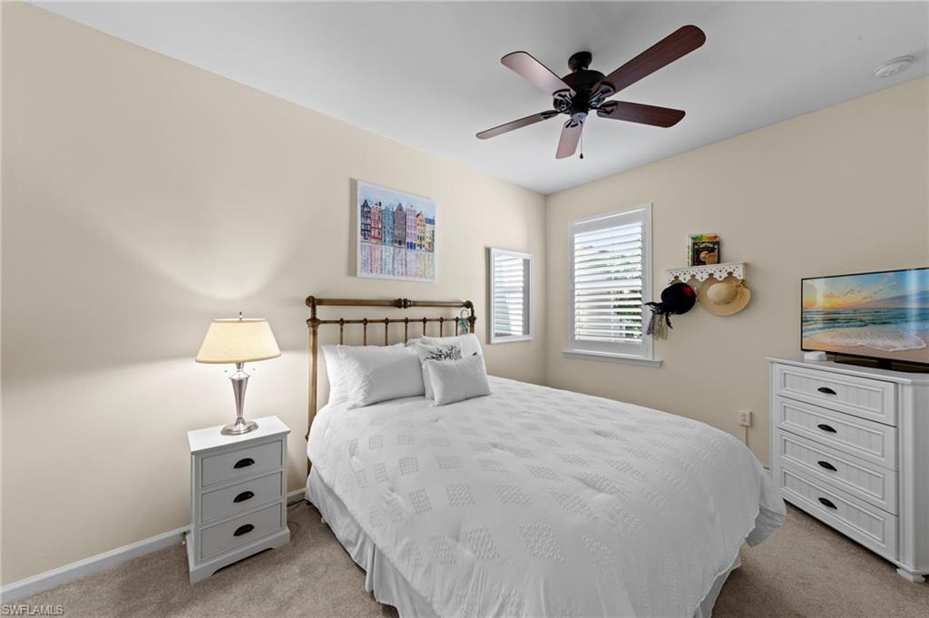 20179 Torch Key Way Estero, FL 33928 - Photo 21 of 41 a bedroom with a bed and a chandelier