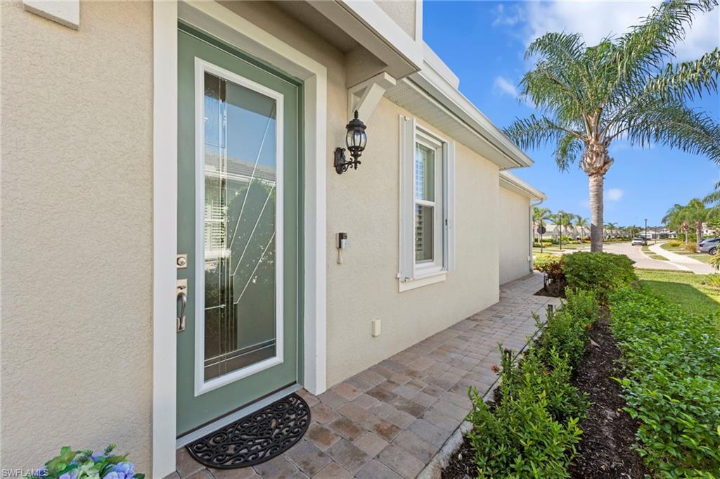 20179 Torch Key Way Estero, FL 33928 - Photo 3 of 41 a view of a door and a yard from a corridor