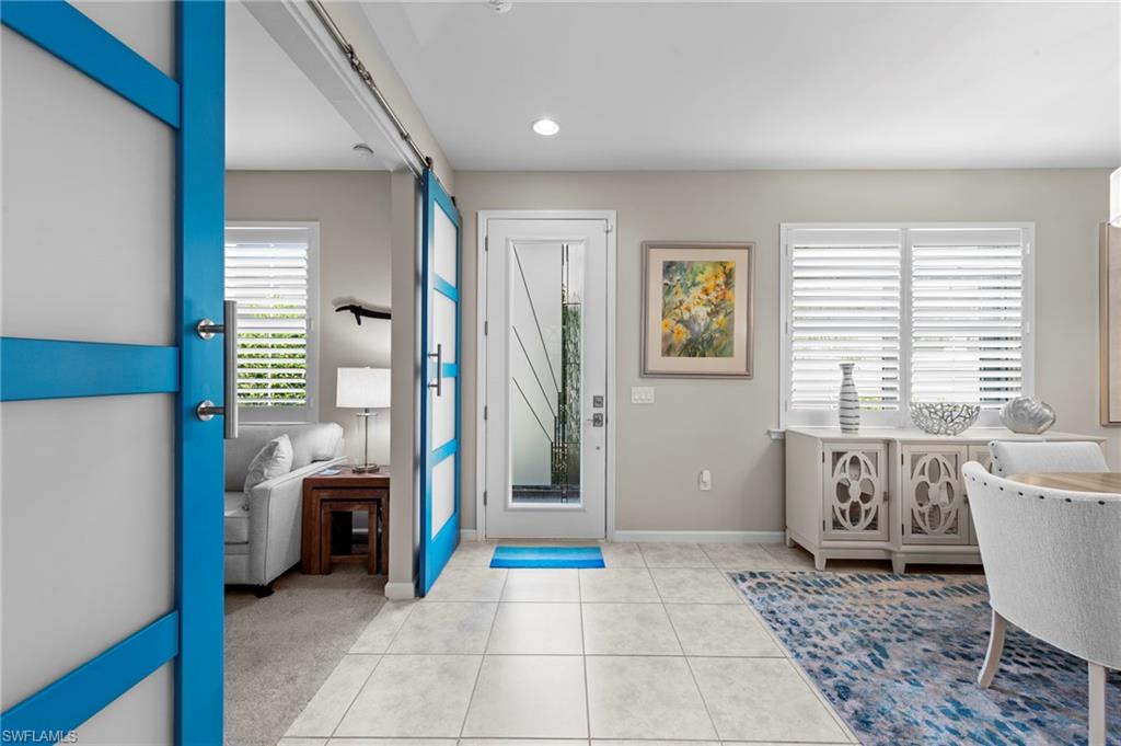 20179 Torch Key Way Estero, FL 33928 - Photo 4 of 41 a living room with stainless steel appliances furniture a rug and a window