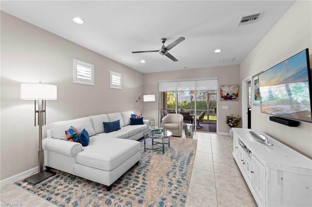 20179 Torch Key Way Estero, FL 33928 - Photo 9 of 41 a living room with furniture and a flat screen tv