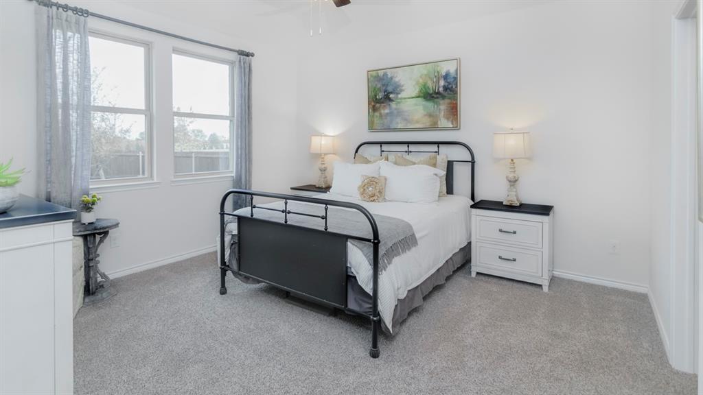 410 Range Road Caddo Mills, TX 75135 - Photo 14 of 19 Bedroom featuring neutral carpeting, white walls, and a ceiling fan