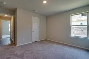 an empty room with windows and closet