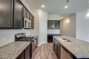 a kitchen with a stove sink and microwave