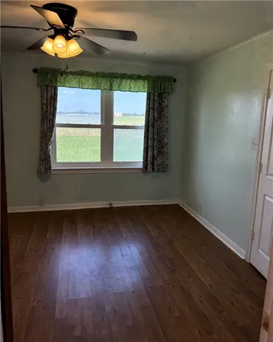 a view of a room with wooden floor and closet