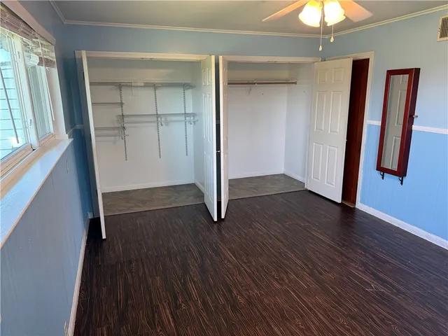 a view of room with window and wooden floor