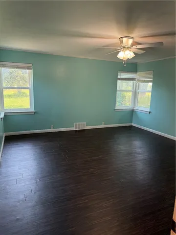 a view of a room with wooden floor and staircase