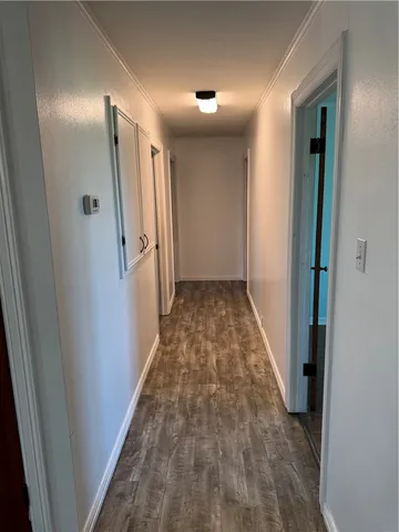 an empty room with closet and wooden floor