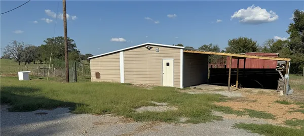 an outdoor view of a house with backyard