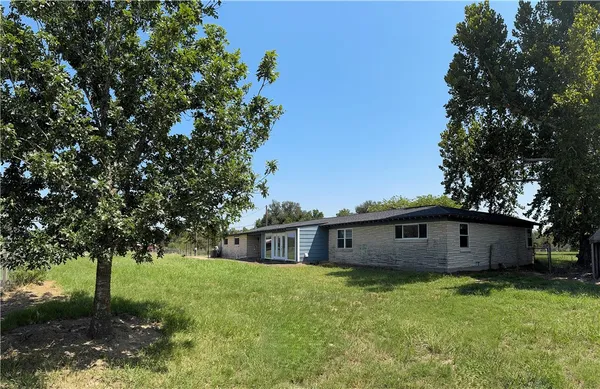a view of a house with a backyard