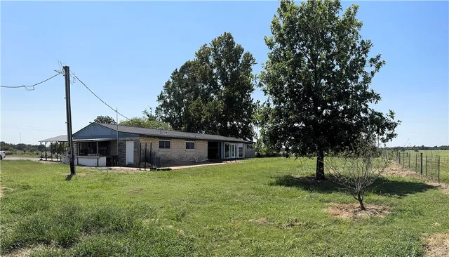 a view of a house with a yard and sitting area
