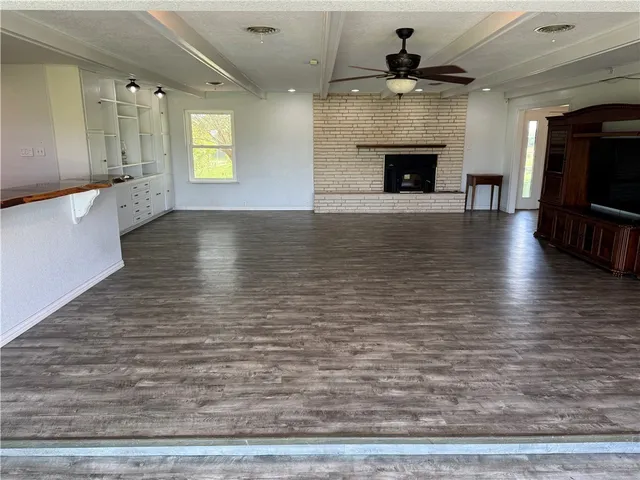 a view of a livingroom with furniture fireplace and wooden floor