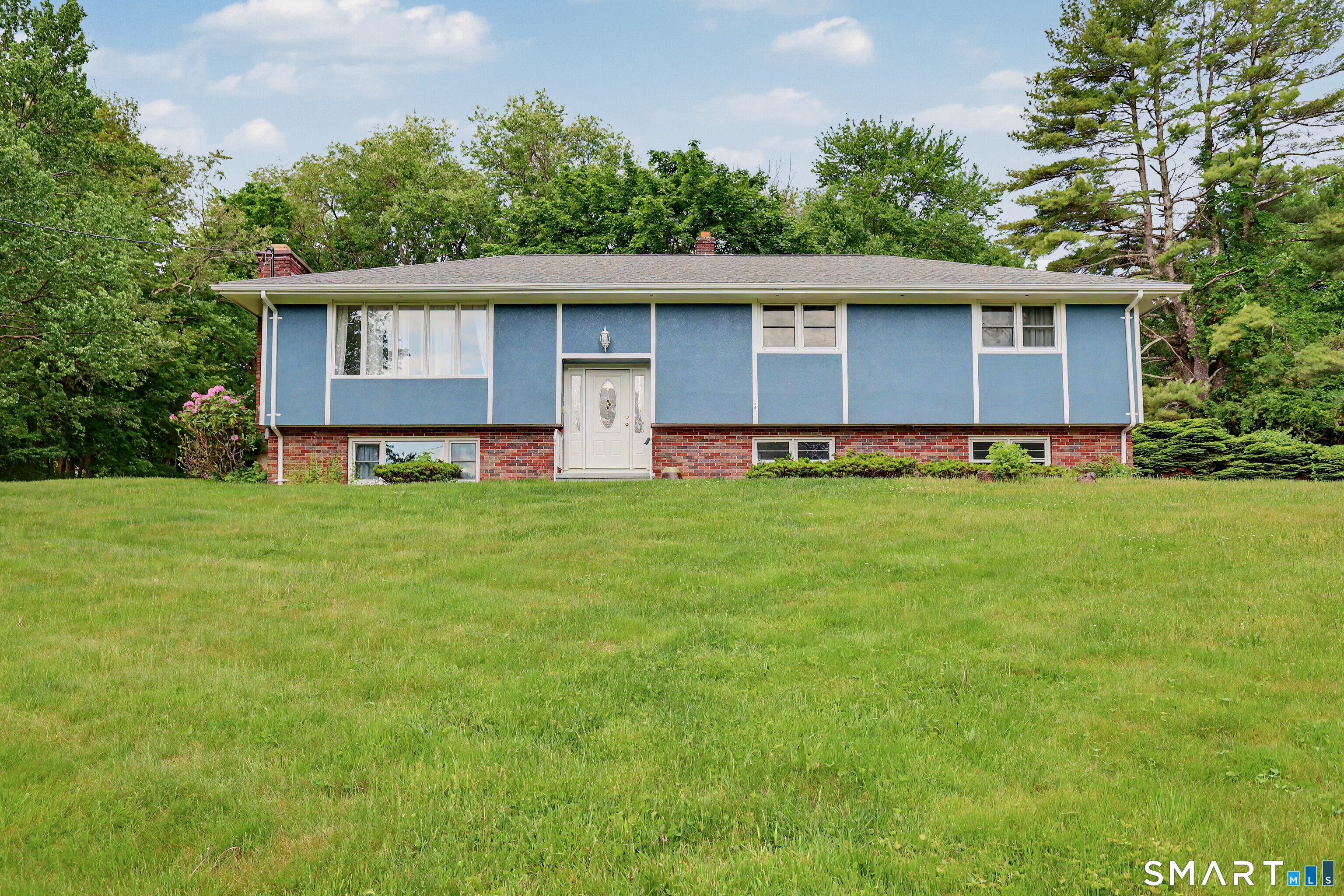44 Haverhill Road Trumbull, CT 06611 - Photo 1 of 32 a front view of a house with a yard and trees