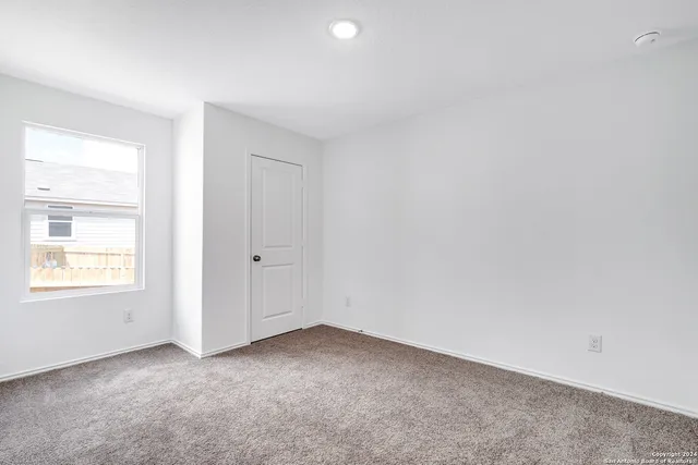 an empty room with closet area