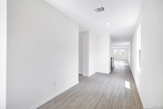 a kitchen with a sink a refrigerator and cabinets