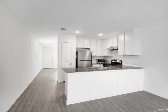 a view of kitchen with wooden floor and window
