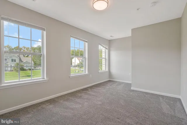 a view of an empty room with windows