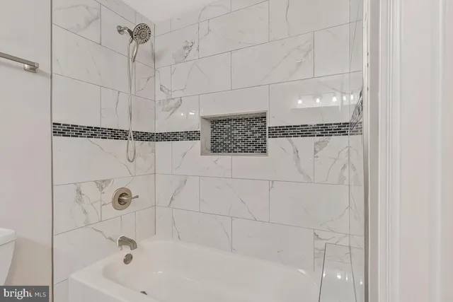 a bathroom with a bathtub and shower