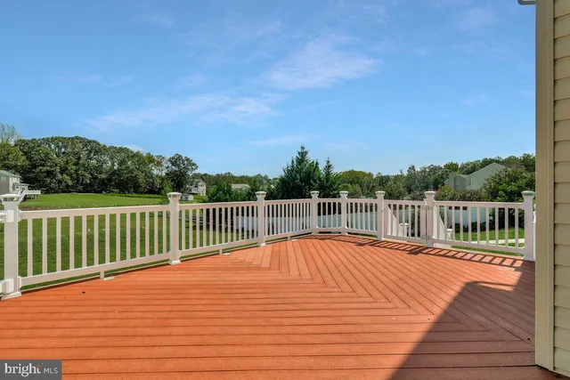 a view of a balcony with wooden floor and fence