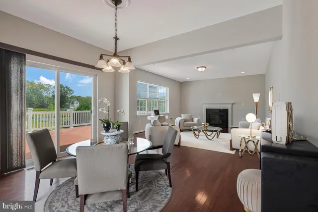 a living room with furniture a fireplace and a chandelier