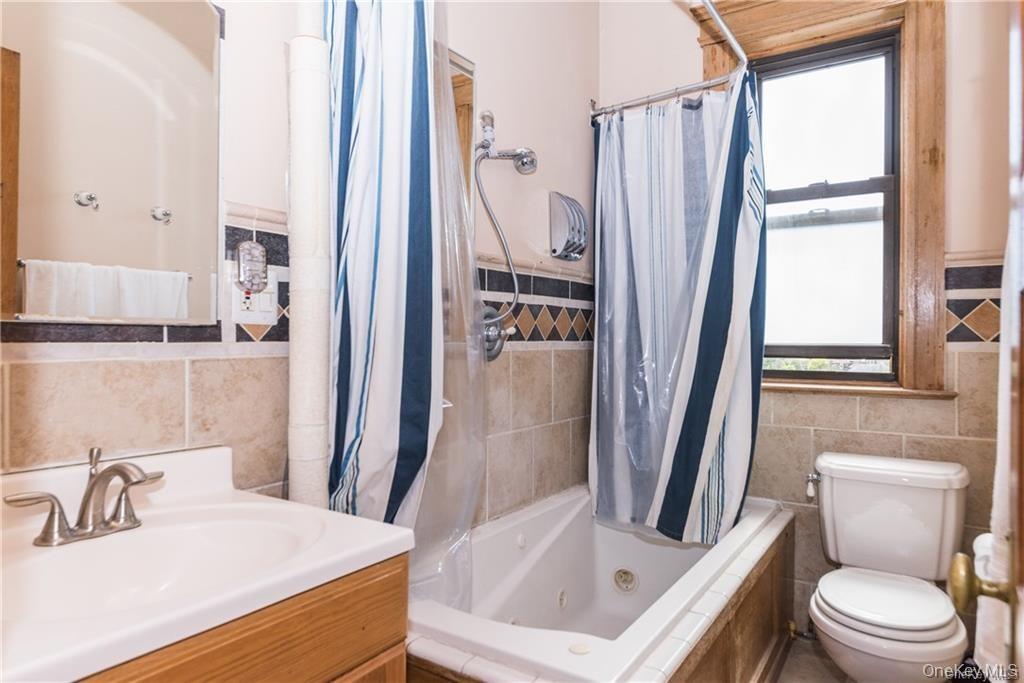 36 Echo Avenue, Unit 5C New Rochelle, NY 10801 - Photo 14 of 18 a bathroom with a sink a toilet and a mirror
