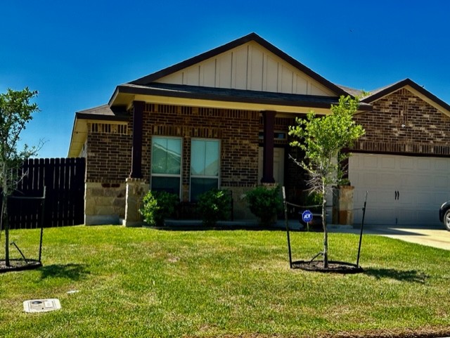 Single story home featuring board and batten sidin