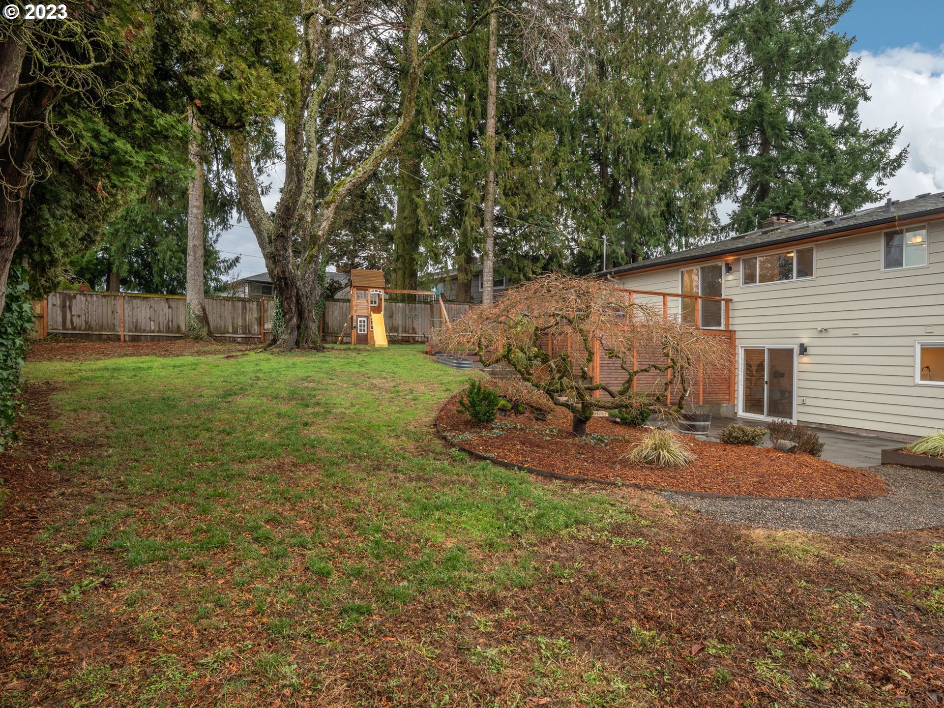 10303 Southeast Stephens Street Portland, OR 97216 - Photo 24 of 32 a view of a backyard with large trees