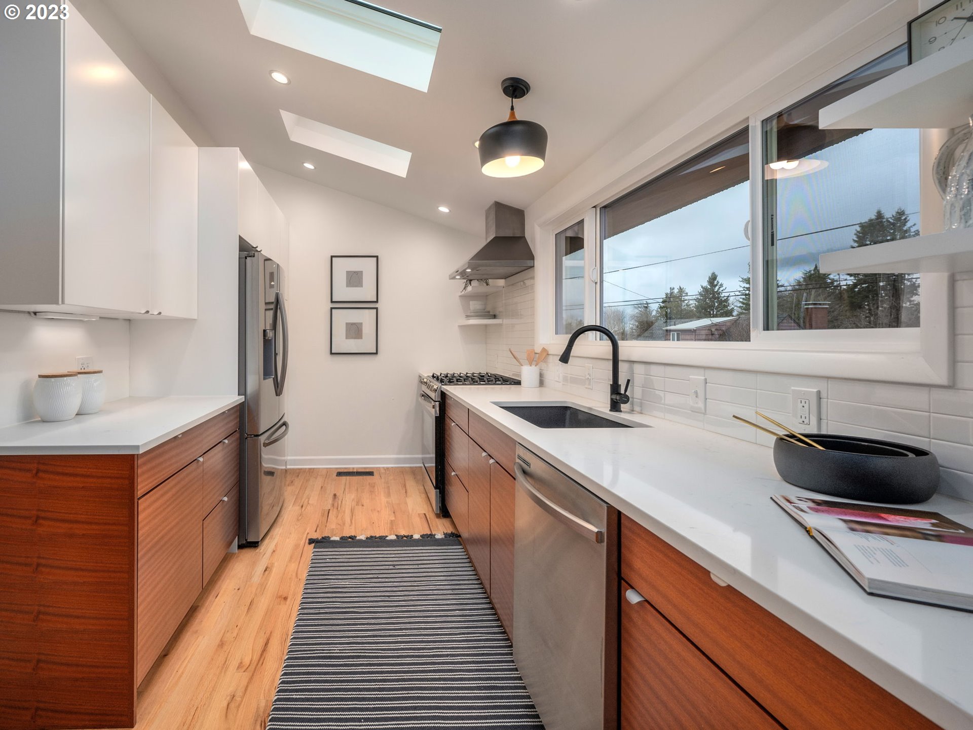 10303 Southeast Stephens Street Portland, OR 97216 - Photo 9 of 32 a kitchen with stainless steel appliances a sink and a stove