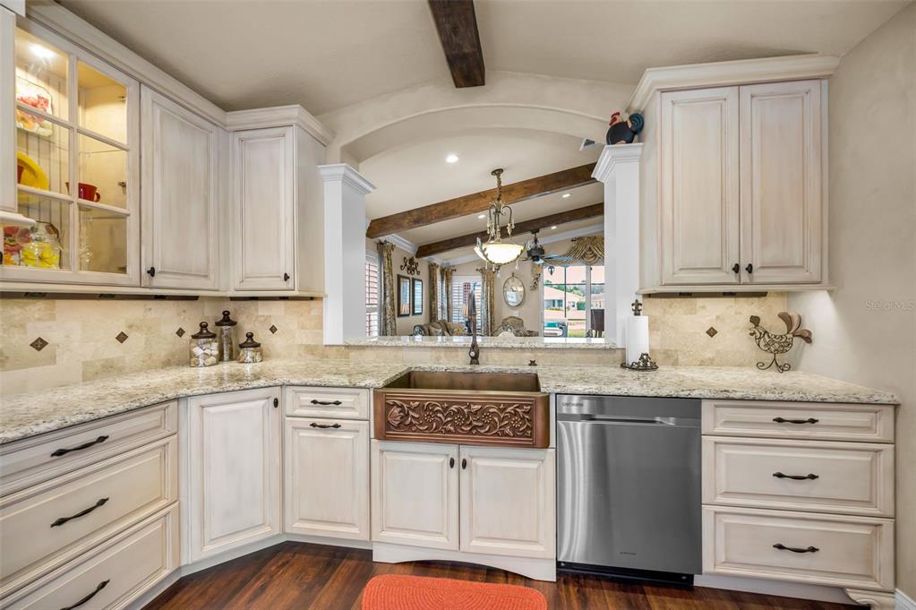 1326 Winding Willow Drive Trinity, FL 34655 - Photo 20 of 100 a kitchen with granite countertop white cabinets and white appliances